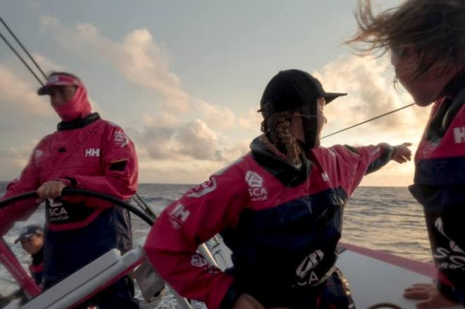 Onboard Team SCA – Sophie Ciszek points out Abu Dhabi Ocean Racing on the horizon to Abby Ehler during a watch change - Leg six to Newport – Volvo Ocean Race 2015 © Corinna Halloran / Team SCA